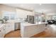 Bright, eat-in kitchen with hardwood flooring, stainless appliances, and white cabinetry at 5855 Saddle Creek Trl, Parker, CO 80134