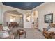 Inviting living room with stone archways and a view into the dining area at 5855 Saddle Creek Trl, Parker, CO 80134