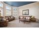 Bright living room with large windows, plantation shutters, and comfortable seating at 5855 Saddle Creek Trl, Parker, CO 80134