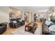Open-concept living room with hardwood floors and views into the dining and kitchen areas at 5855 Saddle Creek Trl, Parker, CO 80134