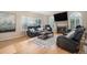 Cozy living room with a fireplace, hardwood floors, and comfortable leather furniture at 5855 Saddle Creek Trl, Parker, CO 80134