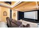 Home theater featuring tiered seating, a projector, and sound dampening features at 5855 Saddle Creek Trl, Parker, CO 80134