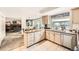 Bright kitchen featuring an island and modern appliances, adjacent to the breakfast nook and living room at 5938 E Weaver Cir, Centennial, CO 80111