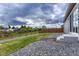Large backyard with gravel and lawn areas and a sturdy wooden fence at 612 Blue Teal Dr, Castle Rock, CO 80104