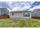 Backyard featuring green grass, landscaping and gray siding at 612 Blue Teal Dr, Castle Rock, CO 80104