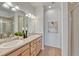 Bathroom with a double sink vanity, well-lit mirrors, and modern fixtures at 612 Blue Teal Dr, Castle Rock, CO 80104