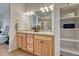 Bathroom featuring a double sink vanity, bright lighting, and convenient storage at 612 Blue Teal Dr, Castle Rock, CO 80104