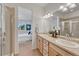 Bathroom featuring a double sink vanity, shower, and ample natural light at 612 Blue Teal Dr, Castle Rock, CO 80104