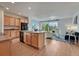 Bright, open kitchen with wood cabinets, a kitchen island, and seamless flow to the living area at 612 Blue Teal Dr, Castle Rock, CO 80104