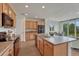 Well-lit kitchen features wood cabinets, stainless appliances, and center island adjoining a cozy breakfast nook at 612 Blue Teal Dr, Castle Rock, CO 80104