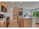 Bright kitchen with a center island, modern appliances, and wooden cabinets providing ample storage space at 612 Blue Teal Dr, Castle Rock, CO 80104