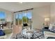 Bright living room featuring modern furniture, large windows offering outdoor views, and stylish decor at 612 Blue Teal Dr, Castle Rock, CO 80104
