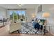 Bright living room features modern decor, hardwood floors, and seamless transition to the breakfast nook at 612 Blue Teal Dr, Castle Rock, CO 80104