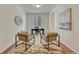 A bright home office space with a dark desk and chair and two side chairs at 612 Blue Teal Dr, Castle Rock, CO 80104