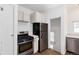 Eat-in kitchen with stainless steel appliances, oven, fridge, and white cabinets at 3336 N Saint Paul St, Denver, CO 80205