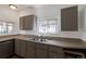 Galley kitchen features stainless steel sink and ample cabinet and counter space at 3336 N Saint Paul St, Denver, CO 80205