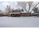 Large backyard with a covered patio, mature trees, and a fully fenced yard at 7835 Nelson St, Arvada, CO 80005