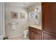 Elegant bathroom featuring a round window and wood vanity with granite countertop at 7835 Nelson St, Arvada, CO 80005