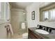 Elegant bathroom featuring a glass shower and dark vanity with granite countertop at 7835 Nelson St, Arvada, CO 80005