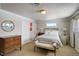 Bedroom featuring a queen bed, natural light, and classic furniture pieces at 7835 Nelson St, Arvada, CO 80005