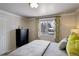 Bedroom featuring a large window with view of snow-covered neighborhood at 7835 Nelson St, Arvada, CO 80005