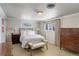 Bright bedroom with a queen-size bed, side tables, and decorative window at 7835 Nelson St, Arvada, CO 80005