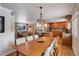 A dining room open to the kitchen and living room has a large wood table with seating for six at 7835 Nelson St, Arvada, CO 80005