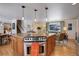 The spacious kitchen features a central island with a cooktop and stainless steel oven at 7835 Nelson St, Arvada, CO 80005