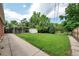 Lush backyard with a well-maintained lawn, mature trees, and a storage shed at 6765 W 33Rd Ave, Wheat Ridge, CO 80033