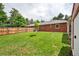 Expansive green backyard is enclosed by a privacy fence and the home's brick exterior at 6765 W 33Rd Ave, Wheat Ridge, CO 80033