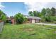 Brick home exterior with well-maintained lawn, driveway, and mature trees at 6765 W 33Rd Ave, Wheat Ridge, CO 80033