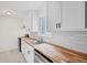 Modern kitchen featuring butcher block counters, white cabinets and stainless steel appliances at 6765 W 33Rd Ave, Wheat Ridge, CO 80033
