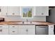 Charming kitchen with white cabinets, butcher block countertop, and subway tile backsplash at 6765 W 33Rd Ave, Wheat Ridge, CO 80033