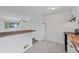 Open-concept kitchen with butcher block counters and bar seating flows seamlessly into the living area at 6765 W 33Rd Ave, Wheat Ridge, CO 80033