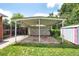Covered patio area with storage shed and grass leading to a privacy fence at 6765 W 33Rd Ave, Wheat Ridge, CO 80033
