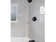 Detailed shot of a shower featuring gray tiled walls and sleek, modern fixtures at 6765 W 33Rd Ave, Wheat Ridge, CO 80033