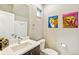 Modern powder room with floating vanity, framed mirror, and fun dog-themed artwork at 2726 Federal Blvd # 1, Denver, CO 80211
