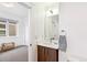 Bathroom with sink and view into bedroom at 2726 Federal Blvd # 1, Denver, CO 80211
