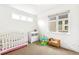 Bright Bedroom with crib, changing table, and ample natural light at 2726 Federal Blvd # 1, Denver, CO 80211