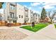 Modern townhome exterior with balconies, green grass, and xeriscaping for low-maintenance living at 2726 Federal Blvd # 1, Denver, CO 80211