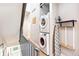 Hallway with stackable washer and dryer and ironing station adjacent to staircase at 2726 Federal Blvd # 1, Denver, CO 80211