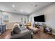 Relaxing living room with hardwood floors and natural light, featuring a TV and comfortable seating at 2726 Federal Blvd # 1, Denver, CO 80211