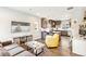 Inviting living room flows into an open kitchen and dining area with hardwood floors at 2726 Federal Blvd # 1, Denver, CO 80211