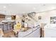 Open-concept living area with bar seating, kitchen, work space and staircase at 2726 Federal Blvd # 1, Denver, CO 80211