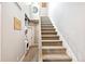 Carpeted staircase with adjacent laundry room and decorative accents at 2726 Federal Blvd # 1, Denver, CO 80211