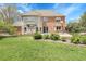Expansive two-story home showcases a well-maintained lawn and back exterior with a mix of brick and siding at 7472 S Utica St, Littleton, CO 80128