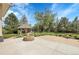 Beautifully landscaped backyard with patio, fire pit, gazebo, lush lawn, and mature trees at 7472 S Utica St, Littleton, CO 80128