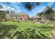 Expansive backyard featuring a lush lawn, beautiful landscaping, brick home, and charming gazebo at 7472 S Utica St, Littleton, CO 80128