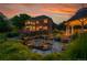 Picturesque backyard oasis featuring a serene pond with water lilies and a charming gazebo at 7472 S Utica St, Littleton, CO 80128