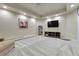 Finished basement with an entertainment center, decorative artwork, gray carpeting, and comfortable seating at 7472 S Utica St, Littleton, CO 80128